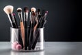 Makeup brushes in a glass. Clean professional makeup brushes set for make-up artist, cosmetics, make up theme. AI generated