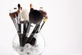 Makeup brushes in a glass vase with crystals Royalty Free Stock Photo