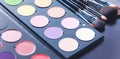 Makeup brushes and make-up eye shadows on desk Royalty Free Stock Photo