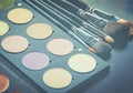 Makeup brushes and make-up eye shadows on desk Royalty Free Stock Photo