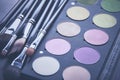Makeup brushes and make-up eye shadows on desk Royalty Free Stock Photo