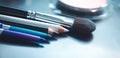 Makeup brushes and make-up eye shadows on desk Royalty Free Stock Photo