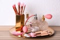 Makeup brushes and perfumes on wooden dressing Royalty Free Stock Photo