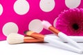 Makeup Brushes On Polka Dots Pink Background .