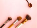 Makeup brushes and powder, forming a circle on a light background. Horizontal template for make-up artist business card or flyer