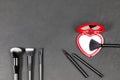 Makeup brushes with a red heart shaped mirror
