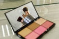 Makeup brushes are reflected in a palette mirror with shadows Royalty Free Stock Photo