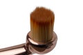 Makeup brushes. Selective focus on the head of a elegant golden professional lip brush for lipstick isolated on a white background Royalty Free Stock Photo