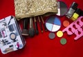 Makeup collection.Eye shadow, makeup brushes on red.