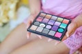 Makeup colorful eyeshadow palette in hands