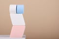 Makeup colorful sponge on white stand on biege background. Blender cosmetic product, powder, foundation. Professional