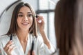 Makeup. Beautiful Young Woman Applying Mascara On Eyelashes, Getting Ready In Bathroom Royalty Free Stock Photo