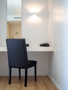 Makeup corner, black chair, black hair dryer in front of the mirror in hotel room Royalty Free Stock Photo