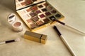 Makeup with cosmetic bag with golden elements on light background