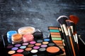 makeup cosmetics beauty tools and brushes infront of black wooden background Royalty Free Stock Photo