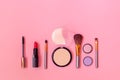 Makeup cosmetics and brushes as border on pink background. Top view, copy space Royalty Free Stock Photo