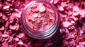 Makeup cosmetics, glittery loose face shadows or blush, glitters in jar, pink glitter background, barbicor style. Beauty