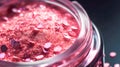 Makeup cosmetics, glittery loose face shadows or blush, glitters in jar, pink glitter background, barbicor style. Beauty