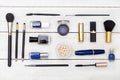 Makeup cosmetics spread out on a wooden background. Flat lay Royalty Free Stock Photo