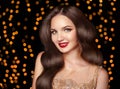 Makeup. Elegant wavy hairstyle. Beautiful brunette smiling with