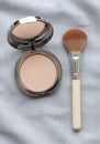 Makeup essentials: powder compact and brush Royalty Free Stock Photo