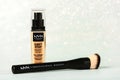 Makeup foundation bottle Can\'stop won\'stop Full coverage foundation NYX professional makeup and makeup brush. Royalty Free Stock Photo