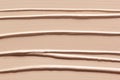 Makeup foundation creamy texture background. Skin tone concealer, color corrector strokes