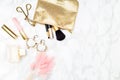 Makeup gold & blush on the desk. Gold styled stock copy space