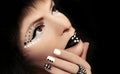 Makeup and manicure with rhinestones.