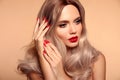 Makeup, manicured nails. Beauty portrait of blonde woman with red lips, long healthy shiny blond hair style. Sensual girl with Royalty Free Stock Photo