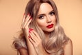 Makeup, manicured nails. Beauty portrait of blonde woman with red lips, long healthy shiny blond hair style. Sensual girl with Royalty Free Stock Photo