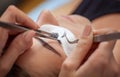 Makeup Master corrects, and strengthens eyelashes beams, holding out a pair of tweezers in a beauty salon.