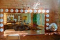 A makeup mirror with light bulbs on a brick wall background Royalty Free Stock Photo