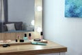 Makeup mirror on table near white wall Royalty Free Stock Photo