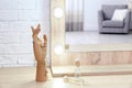 Makeup mirror on table near white wall in room Royalty Free Stock Photo