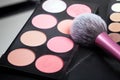Makeup palets and brush on black lather. Royalty Free Stock Photo