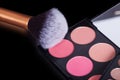 Makeup palets and brush on black lather. Royalty Free Stock Photo