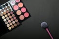 Makeup palets and brush on pure black background. Royalty Free Stock Photo
