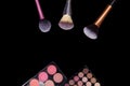 Makeup palets and brushes on pure black background. Royalty Free Stock Photo