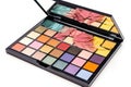 makeup palette with a selection of colorful eye shadows, blushes, and lipsticks