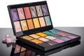 makeup palette with a selection of colorful eye shadows, blushes, and lipsticks