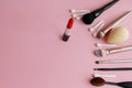Makeup powder and black powder brush on pink backgroundmakeup brushes and red lipstick on a pink background Royalty Free Stock Photo