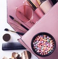 Makeup products with cosmetic bag on white background Royalty Free Stock Photo