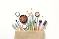 Makeup products and cosmetic bag on white background Royalty Free Stock Photo