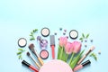 Makeup products, flowers and cosmetic bag, flat lay with space for text Royalty Free Stock Photo
