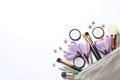 Makeup products, flowers and cosmetic bag, top view Royalty Free Stock Photo