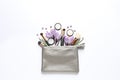 Makeup products, flowers and cosmetic bag on white background Royalty Free Stock Photo
