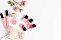 Makeup products with pink English rose on light background. Beauty flat lay with cosmetic bottles and flower. Royalty Free Stock Photo