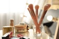 Makeup products and set of cosmetic brushes on table. Interior element Royalty Free Stock Photo