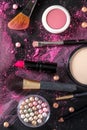 Makeup products and tools, overhead flat lay shot on a dark background Royalty Free Stock Photo